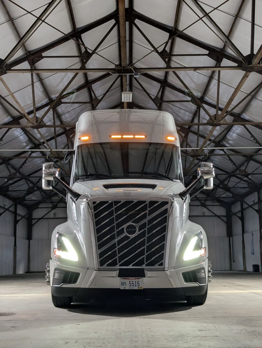 A late-model white Ploger Volvo tractor parked in the company shop